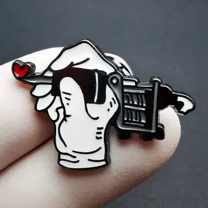 Enamel tattoo machine pin with cartoon heart and shopping cart design in black and white