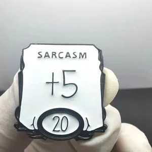Enamel pin with Sarcasm +5 design for RPG games, shown on hand for size perspective