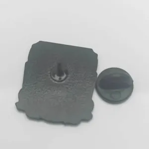 Detail of metal pin back with secure black rubber clutch and sharp needle fastener