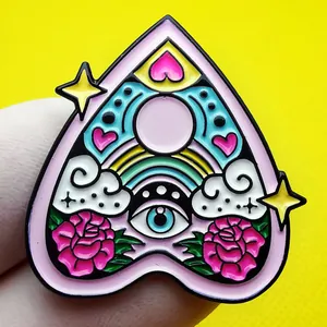 Planchette enamel pin with rainbow heart and rose flower motifs on yellow backdrop