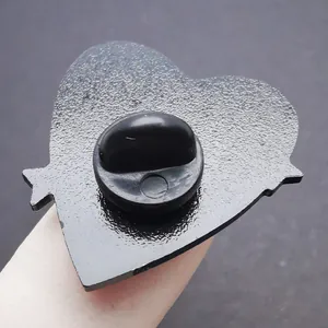 Macro view of the black heart enamel pin back featuring a durable rubber clutch fastener