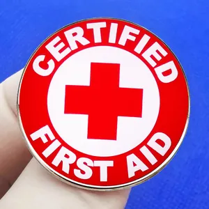 Professional red cross certified first aid metal enamel pin badge held in hand