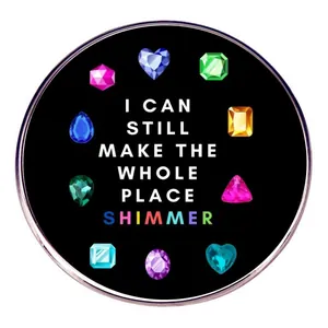 Taylor music brooch with shimmer lyrics and colorful gems on a black enamel pin