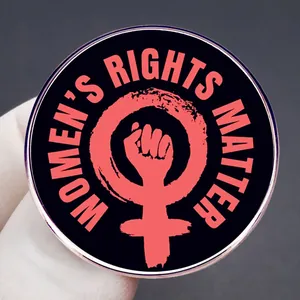 Round Women's Rights Matter enamel pin with pink feminist power fist on black background