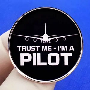 Round pilot brooch pin with white airplane silhouette and Trust Me I'm a Pilot text