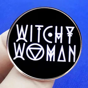 Witchy Woman enamel pin badge in rose gold and black finish held in hand