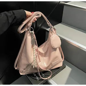 Pink glossy faux leather tote bag with metallic leaf charm and small round pouch