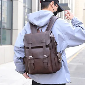 Vintage dark brown PU leather backpack for men featuring double buckle straps and side pockets
