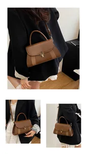 Detail showing the brown vintage handbag with striped fabric inlay and golden lock