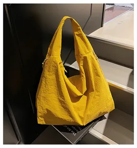 Side view of ginger yellow pleated tote bag placed on steps for a minimalist look