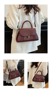 Detailed views of a burgundy trapezoid handbag featuring gold lock and diamond textures