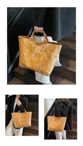 Detail view of brown tote bag with paper texture, PVC coating and white TOTE BAG text