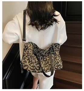 Fashionable large capacity leopard print tote bag shown on model in a modern setting