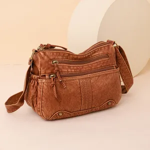 Vintage brown washed leather crossbody bag with multiple zippers and side pockets