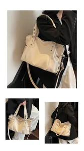 Macro detail of creamy white leather tote featuring silver hardware and adjustable strap