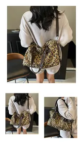 Detail of leopard print canvas tote bag featuring premium leather handles and large capacity