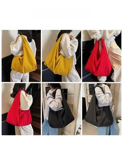 Three minimalist tote bags in yellow, red, and black colors displayed by a model