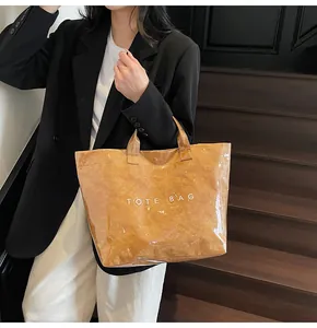 Detail of waterproof brown paper tote bag with clear PVC layer and white text