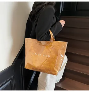 Detail of waterproof brown Tyvek tote bag with glossy finish and Tote Bag text print
