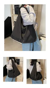 Macro view of the large capacity black nylon tote bag with pleated design and stitching