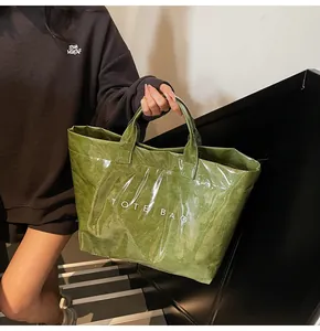 Detail of green tote bag with crinkled paper texture and transparent waterproof finish