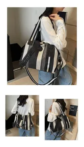 Detail of striped woven tote bag featuring embroidered N logo and wide shoulder strap
