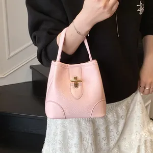 Chic pink bucket handbag for women with lychee pattern leather and gold metal lock