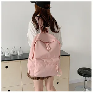 Rear view of a pink nylon backpack featuring durable straps and braided rope zippers