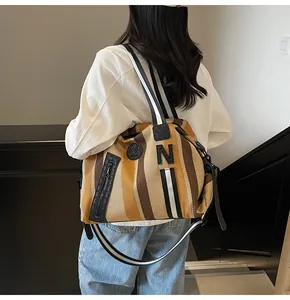 Detailed back view of a striped large-capacity tote bag worn over the shoulder