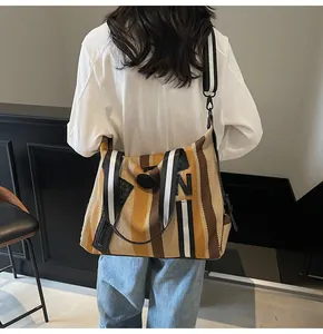 Striped woven tote bag with wide contrast shoulder strap and large capacity detail