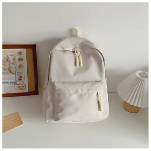 Detail of minimalist beige backpack with woven rope zipper and durable canvas texture