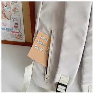 Detail of canvas backpack back zip pocket with card showing hidden storage feature