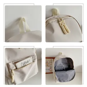 Detail view of cream backpack features woven zipper pulls and interior compartments