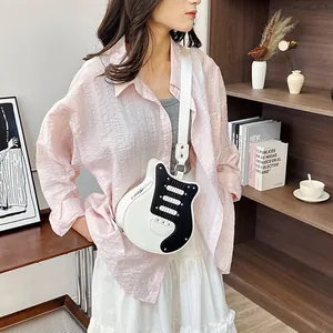 Close-up of a creative guitar-shaped crossbody bag with black and white color blocking