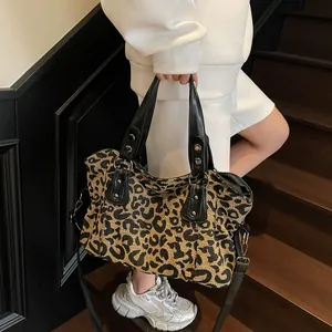 Stylish leopard print tote bag with black leather handles and metal rivets for travel