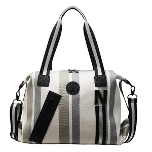 Large striped canvas shoulder bag with leather trim and adjustable crossbody strap