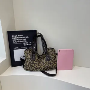 Stylish leopard print tote bag with leather handles and adjustable shoulder strap for travel