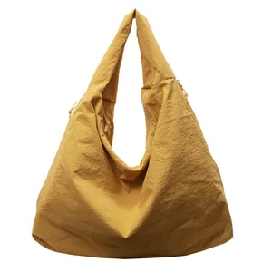 Bright yellow large capacity tote bag with pleated texture and wide shoulder strap