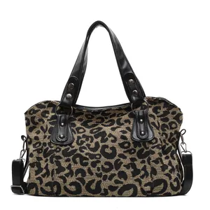 Leopard print crossbody travel tote bag with black handles and silver hardware