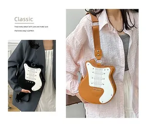 Detail of guitar-shaped crossbody bags in black and brown featuring realistic string decor