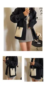 Detail of woven straw mini bag with black trim contrast and crossbody strap design