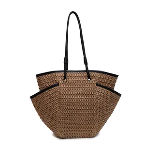 Large woven straw tote bag with black leather straps for beach and casual summer wear
