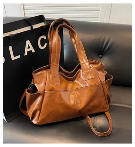 Detail view of a vintage brown large capacity tote bag with functional front and side pockets
