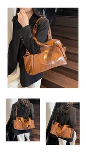 Detail view of large brown vintage tote bag with adjustable shoulder straps and side pocket
