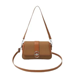Brown woven patchwork crossbody bag with silver oval metal lock and dual straps