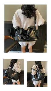 Detail of black faux leather tote bag with side pockets and adjustable shoulder strap