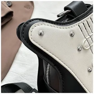 Detail of guitar-shaped bag with silver studs and premium black leather stitching