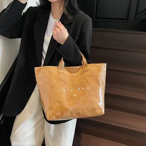 Stylish transparent PVC tote bag with brown paper interior and tote bag print