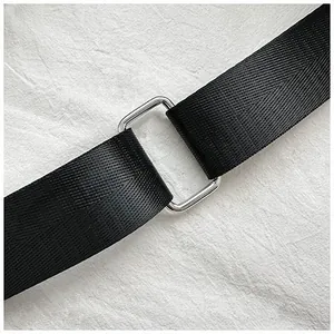Detail of durable black herringbone nylon strap with polished silver metal buckle