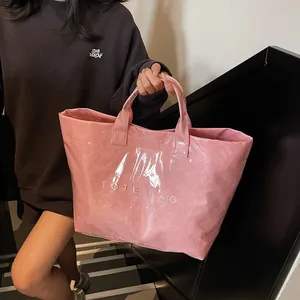 Pink glossy tote bag with white TOTE BAG text on a stylish staircase background